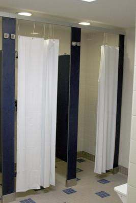 a bathroom stall with white curtains