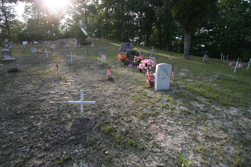 a cemetery with flags and crosses