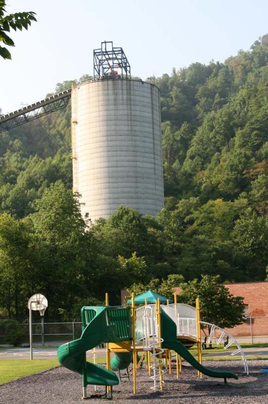 a playground with a silo in the background