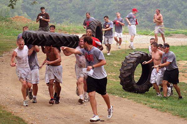 a group of people carrying tires