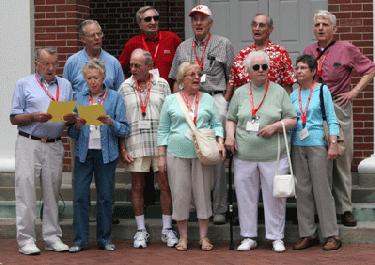 a group of old people standing outside