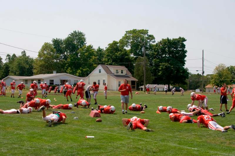 a group of people in red uniforms on a field