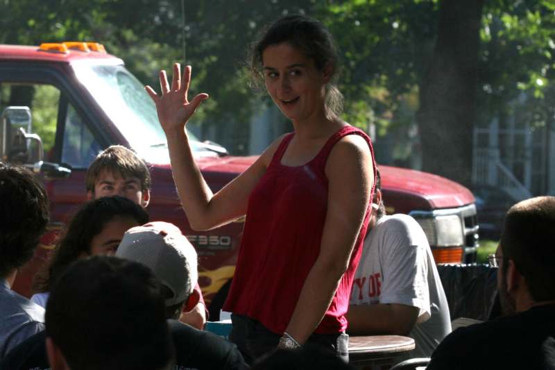 a woman waving in a crowd