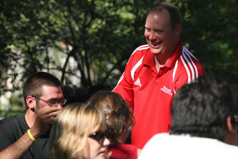a man in a red shirt laughing