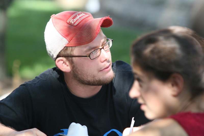 a man wearing a red and white hat and glasses