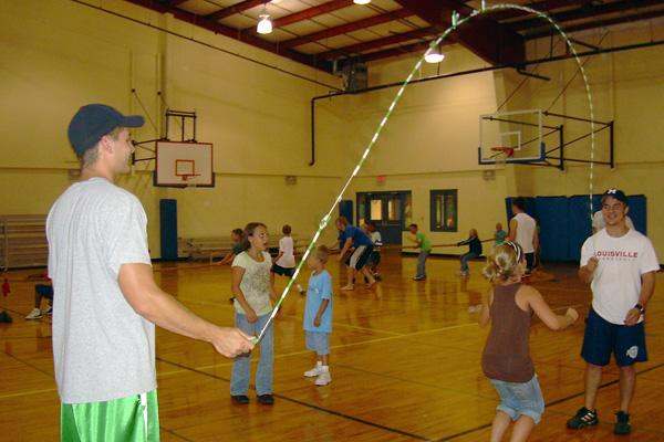 a man holding a stick in a gym