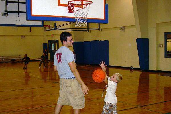 a man and child playing basketball
