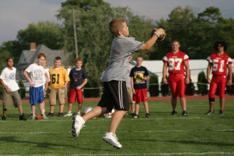 a young boy throwing a football