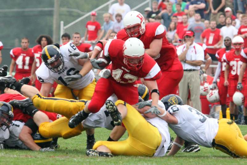 a football player being tackled by other players
