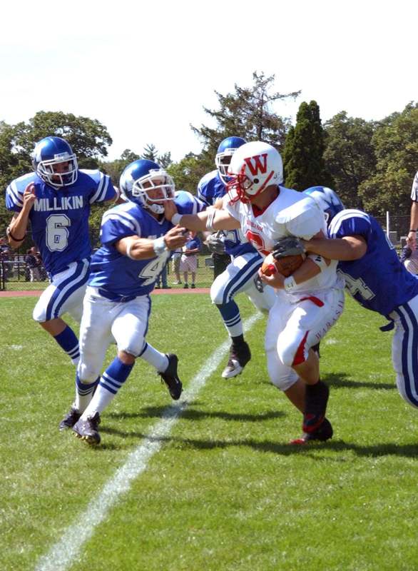 a group of football players running on a field