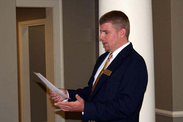 a man in a suit reading a paper