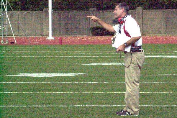 a football coach pointing at something