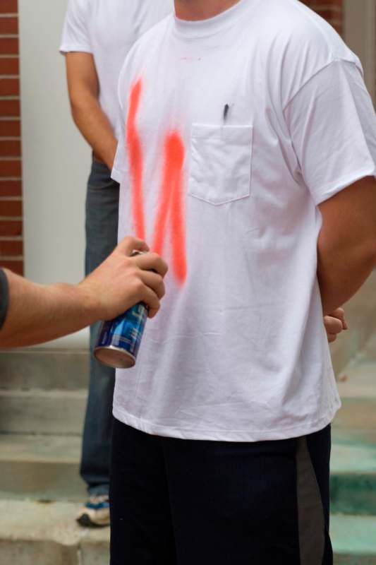 a person with a spray can on his shirt