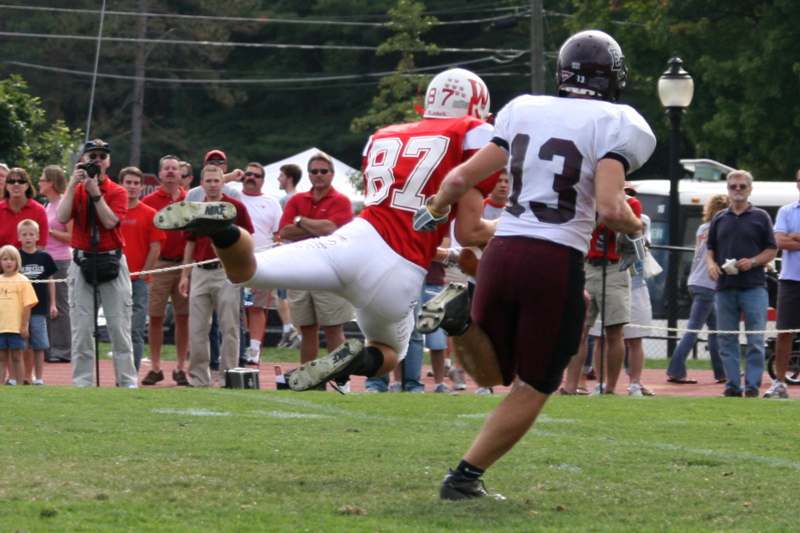 a football player kicking another football player