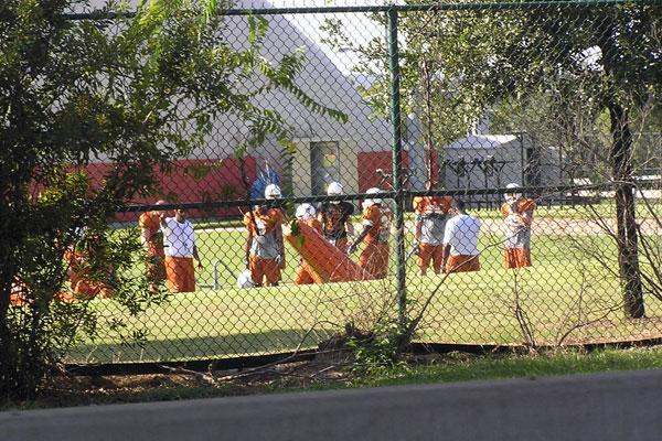 a group of people in orange uniforms