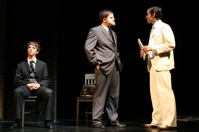 a group of men in suits on a stage