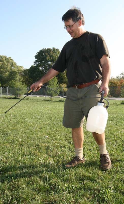 a man spraying a lawn