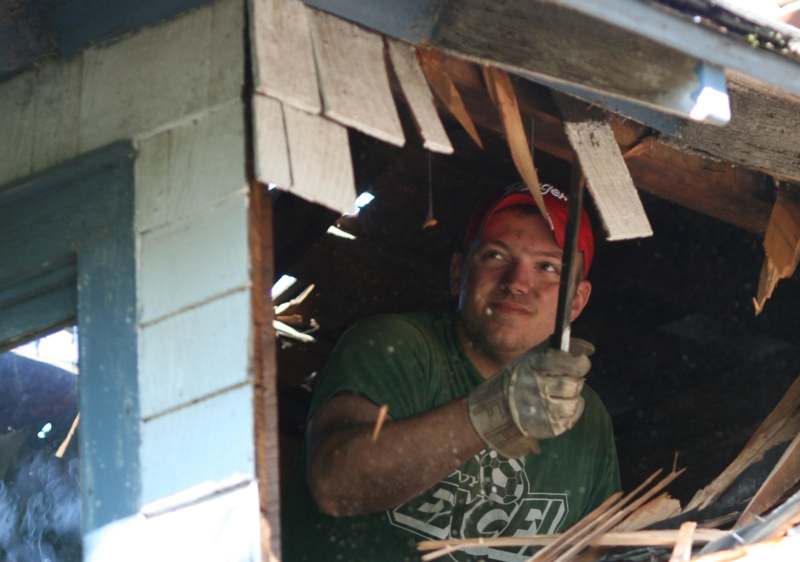 a man holding a hammer in a window