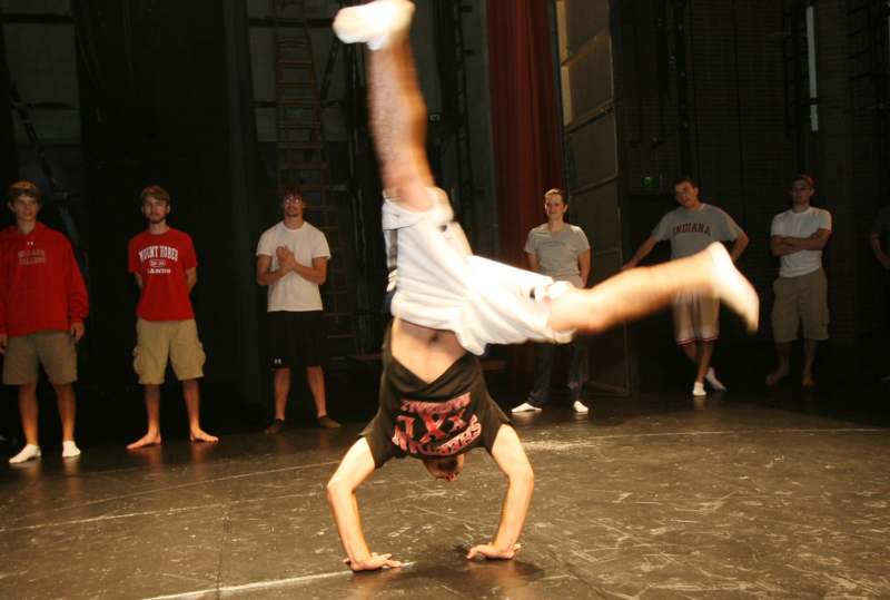 a man doing a handstand on a stage