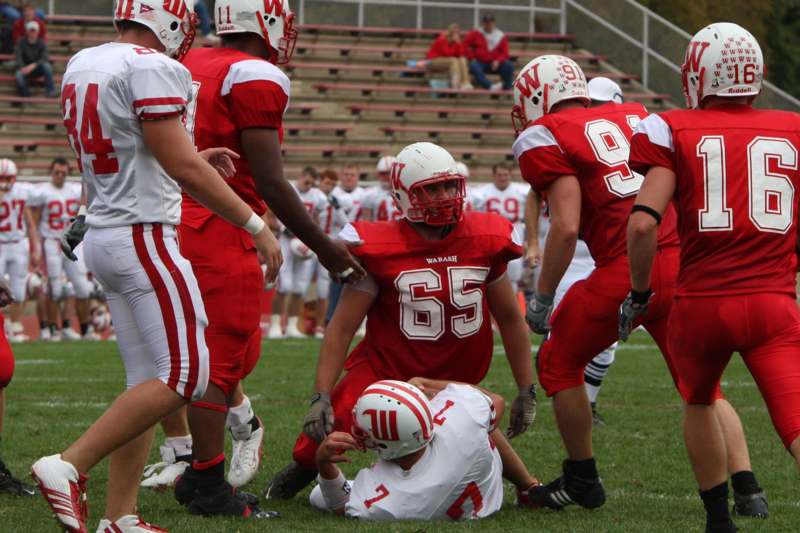 a football player being helped by his team