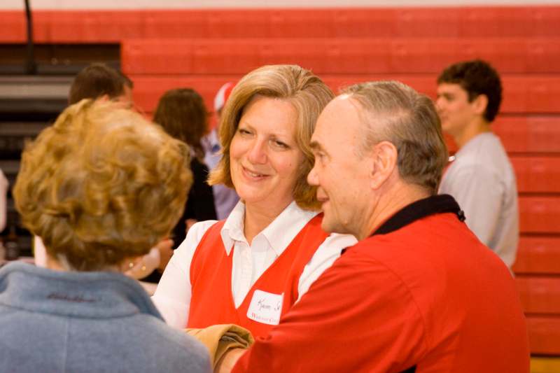 a woman and man in a red vest