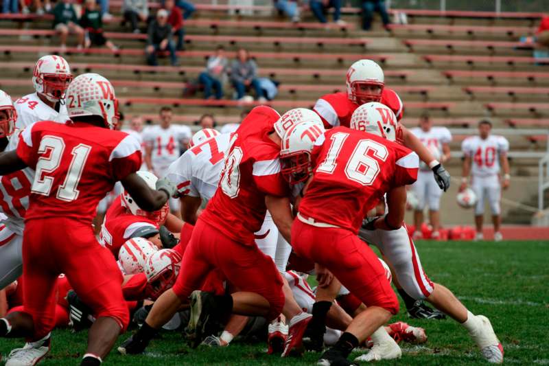 a group of football players in red uniforms