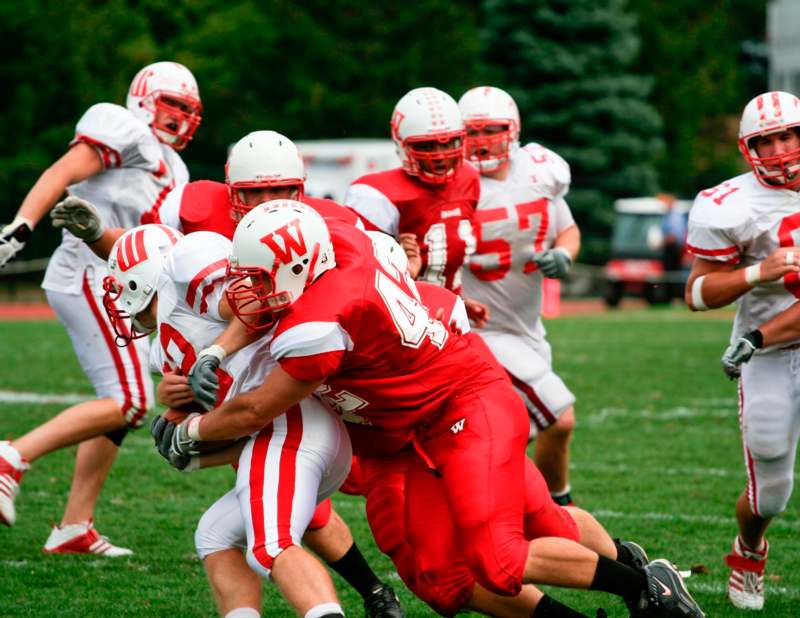 a group of football players in red and white uniforms