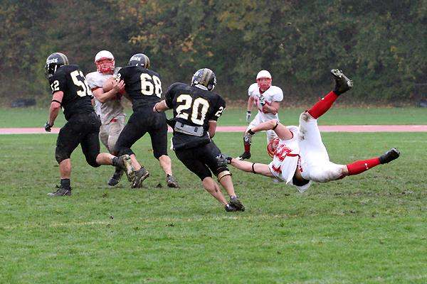 a football player falling off of the ground