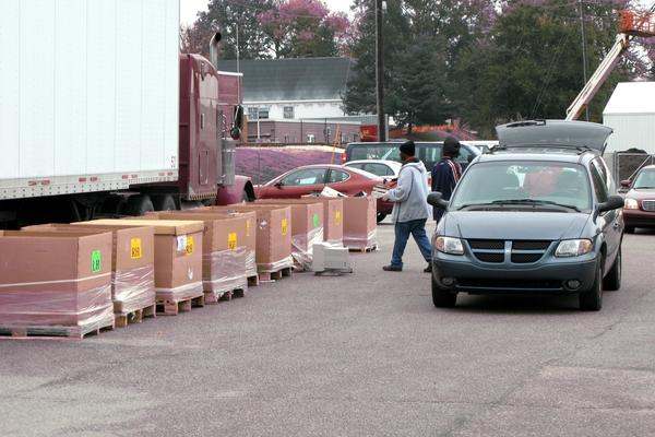 a group of cars and trucks with boxes