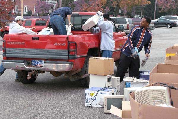 a group of men loading boxes into a truck