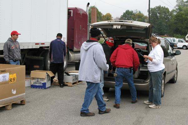 a group of people standing in the back of a truck