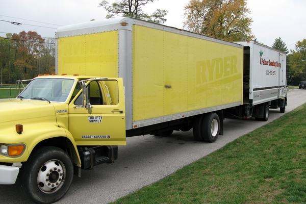 a yellow truck with a white trailer