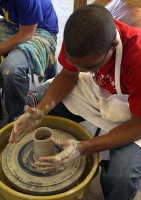 a man working on a pottery wheel