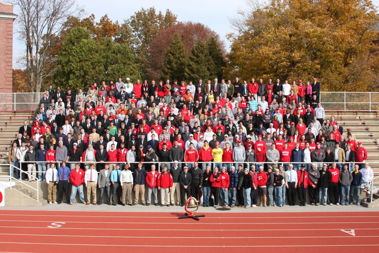 a large group of people standing on a track