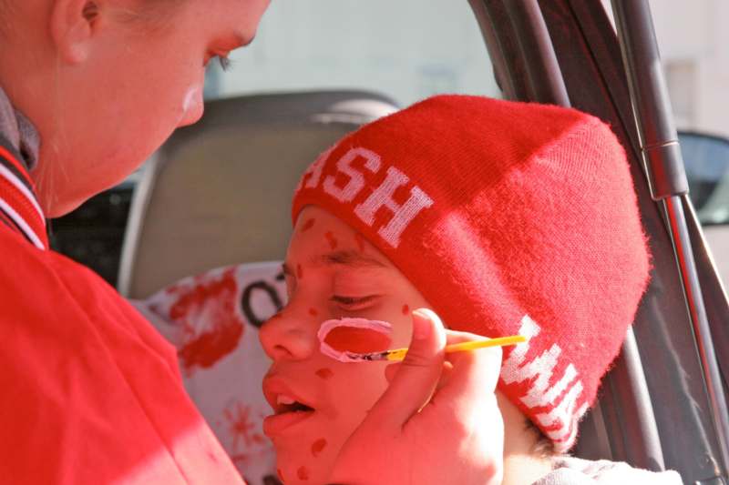 a person painting a child's face