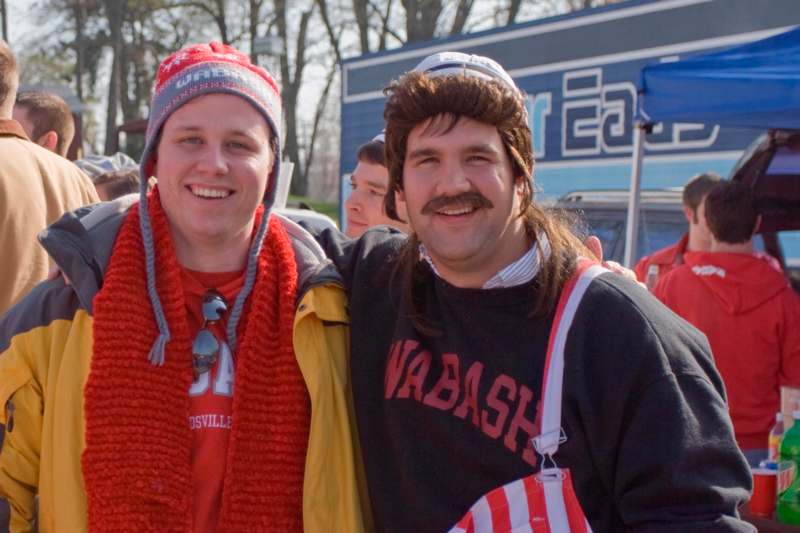 a couple of men wearing hats and scarves