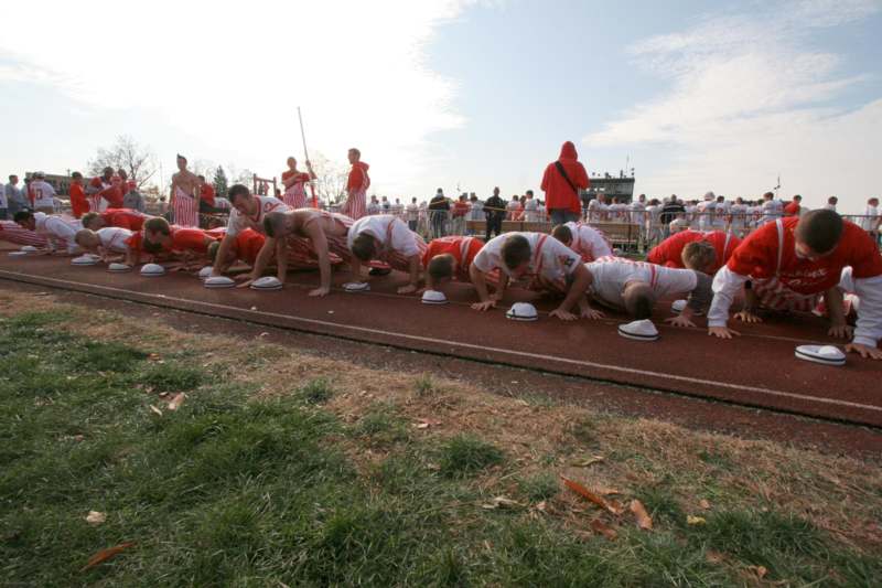 a group of people doing push ups on a track