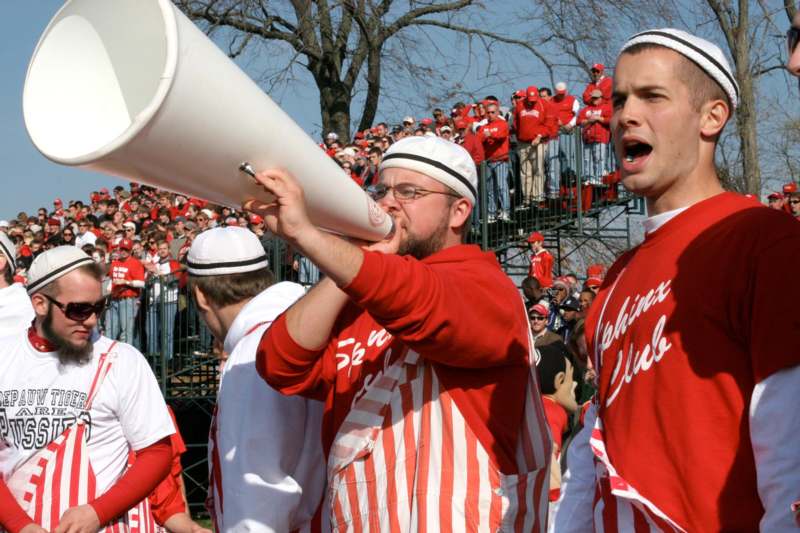 a man in red and white uniform with a megaphone