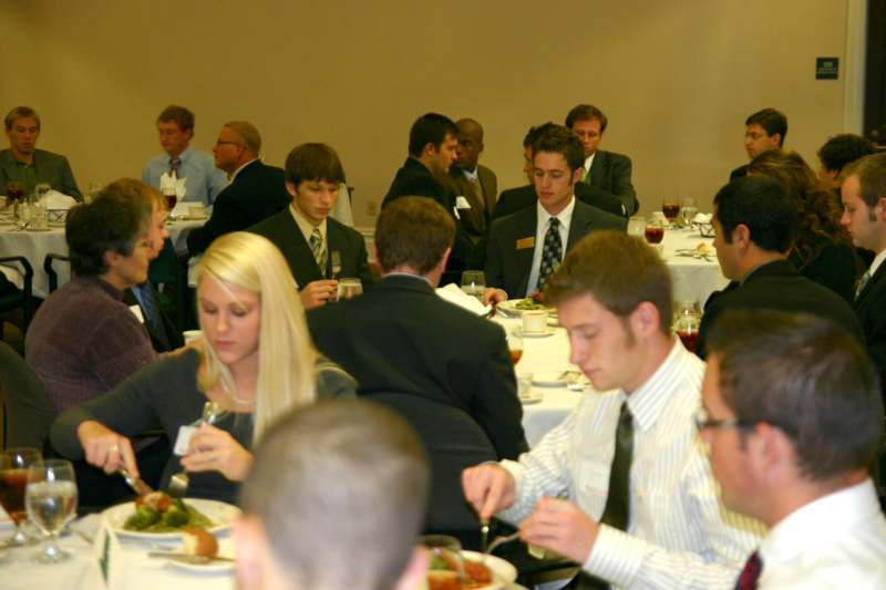 a group of people eating at a banquet