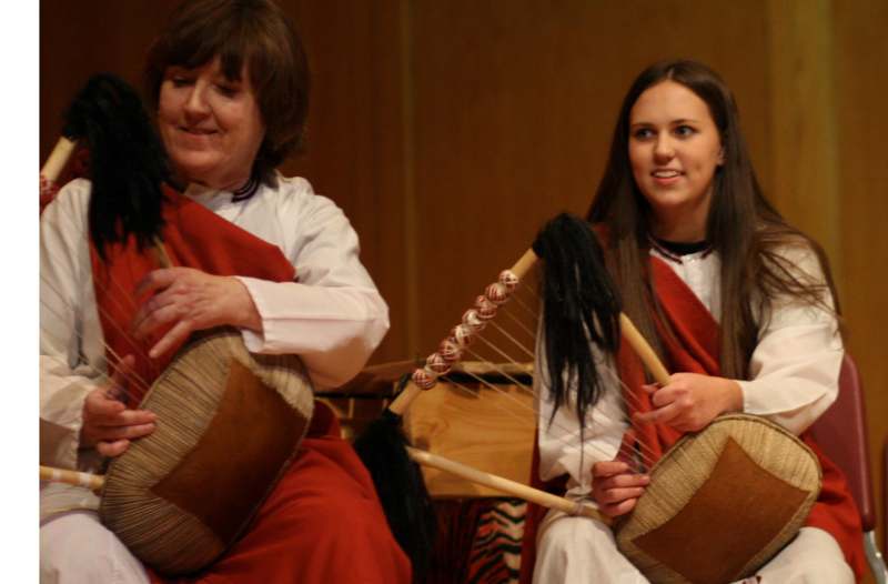 a woman playing instruments with another woman