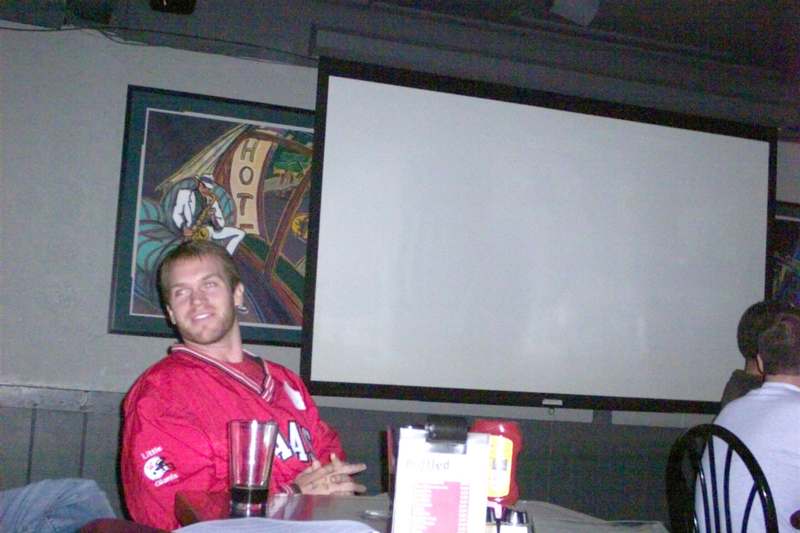 a man sitting in front of a projection screen