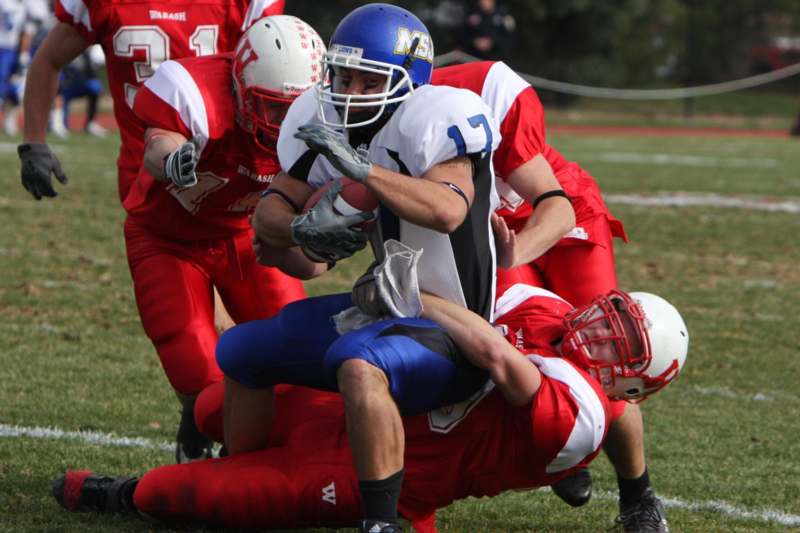 a football player being tackled by other players