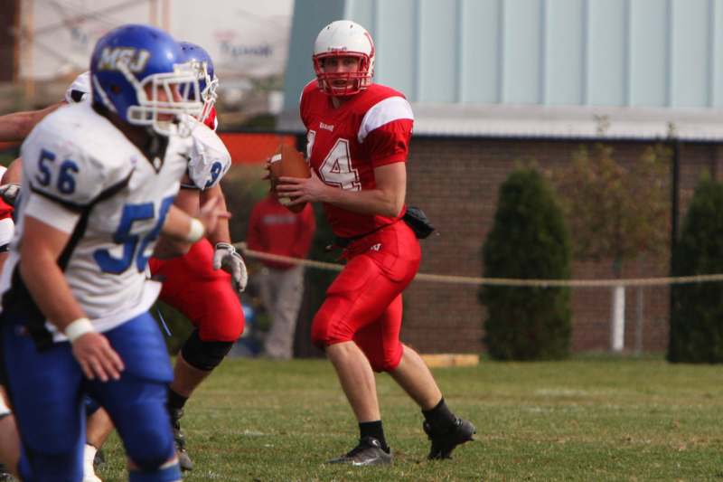 a football player in red uniform holding a football