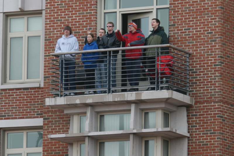 a group of people standing on a balcony