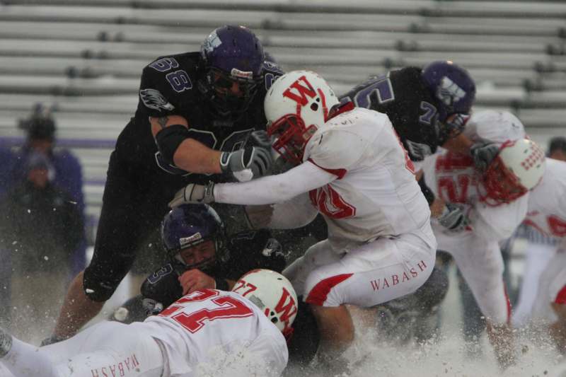 a group of football players in a snowy stadium