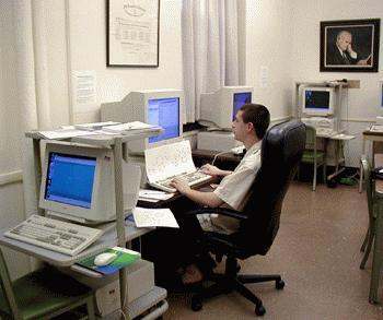 a man sitting in a chair using a computer