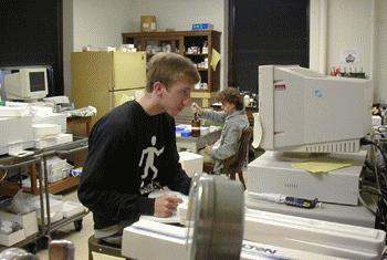 a young man sitting at a desk