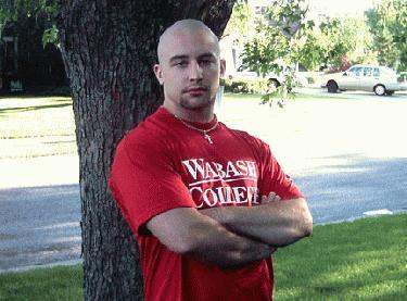 a man standing next to a tree