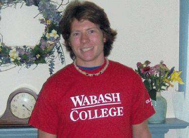 a man smiling in a red shirt