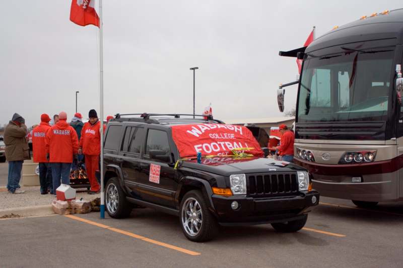 a black suv with a red banner on the hood